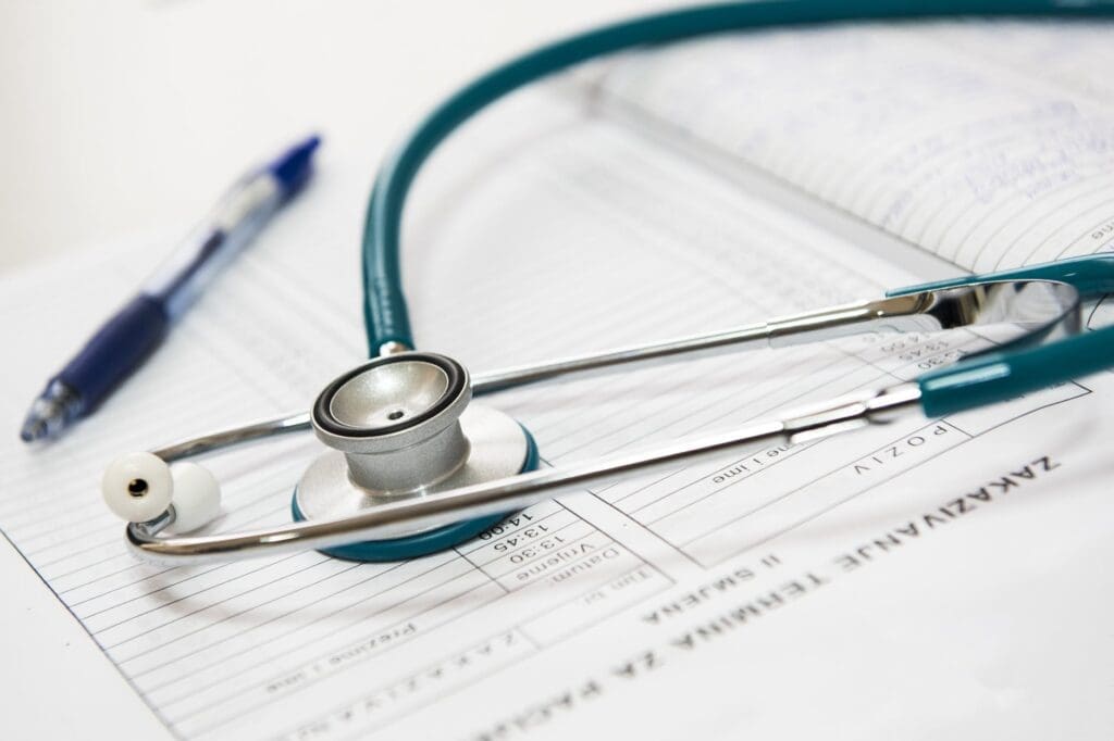 A stethoscope sitting on top of some papers.