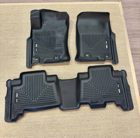 A set of all weather floor mats on top of a table.