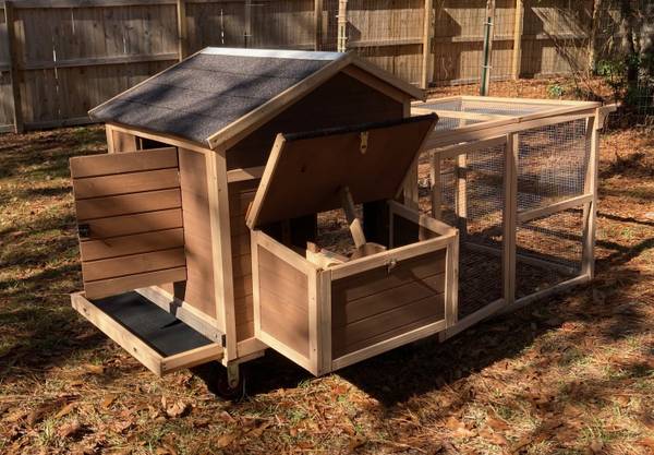 A dog house with a wooden roof and a chicken coop.