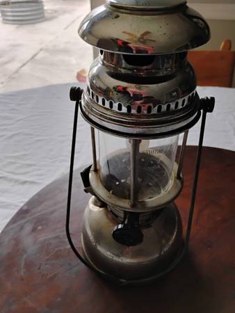 A lantern sitting on top of a wooden table.