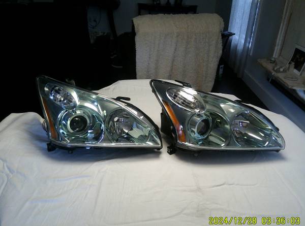 Two headlights are sitting on a table.