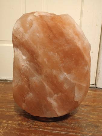 A large rock shaped salt lamp sitting on top of a table.