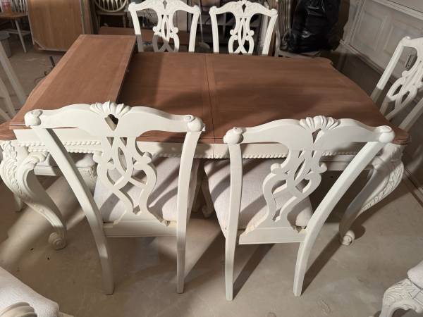 A table with four chairs and a bench.
