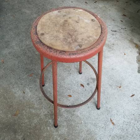 A stool that is sitting on the ground.