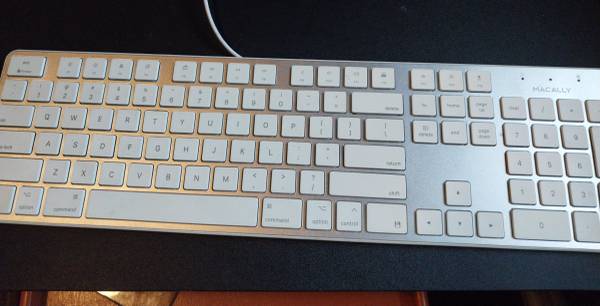 A keyboard sitting on top of a table.