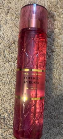 A bottle of perfume sitting on top of the carpet.