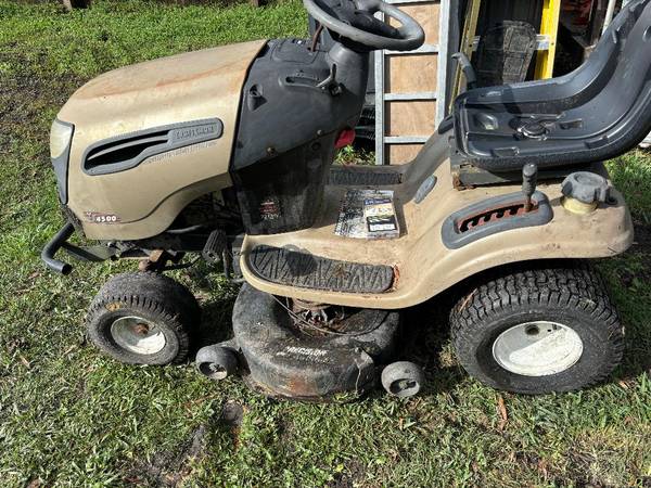 A lawn mower sitting on top of grass.
