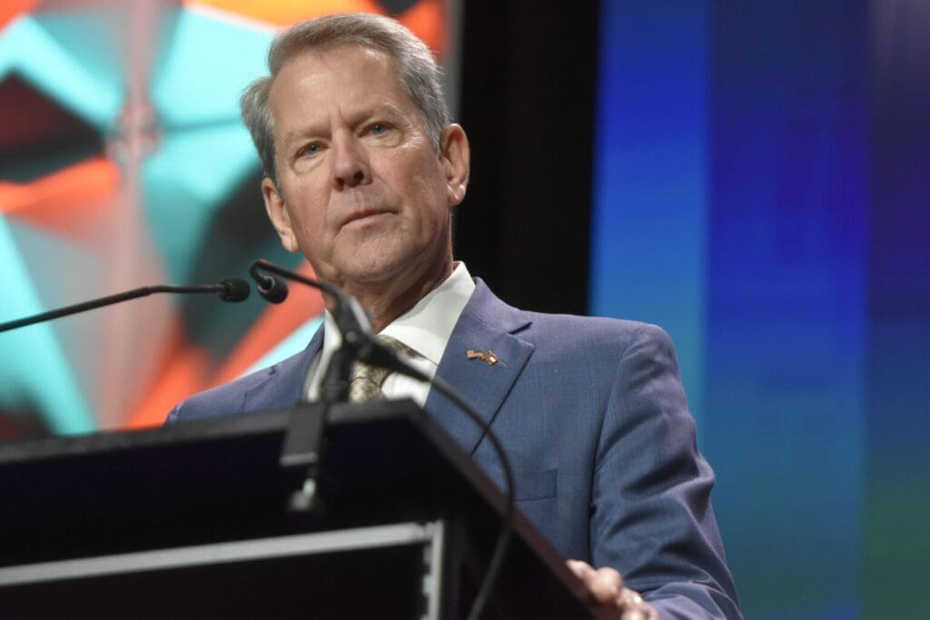 A man in a suit and tie standing at a podium.