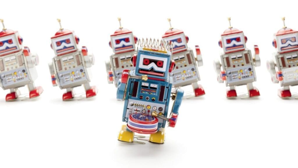 Tin robots dance in a stock photo.