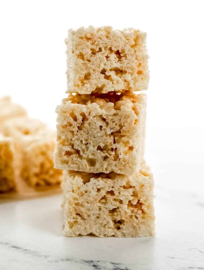 Close up side view of rice krispie treats stacked on top of each other.