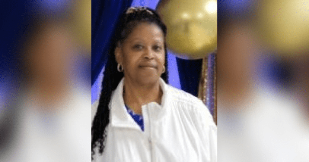 Woman in white jacket, braided hair.