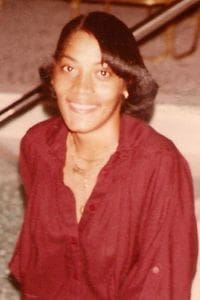 Sylvia Dickson Broomfield's Obituary Smiling person in a red shirt indoors.